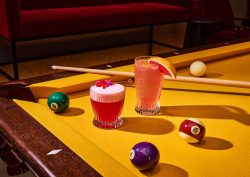 pink cocktails on a bright yellow pool table at Wonder Room Singapore