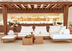 Wooden outdoor furniture at beach bar at Domes Noruz Kassandra