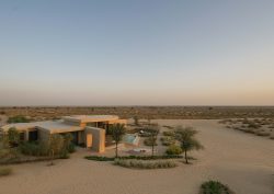 view across desert and Bab Al Shams desert villa