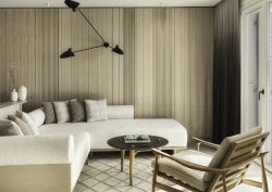wood panelling and cream couch in suite at DEOS Set collection
