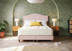 green wallpaper with bed and pink headboard in arched alcove