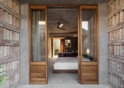 view through into guestroom at Hotel Humano with raw concrete and wood surfaces