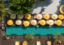 aerial view of yellow umbrellas around pool Hyde Bali