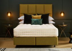 Chartreuse bed and headboard with Hypnos mattress, in dark coloured bedroom with low lighting from pendants either side of bed