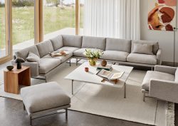cream L shaped Lissoni couch from Fritz Hansen in front of floor to ceiling window