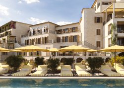 Hotel MArgalida on Mallorca view from pool with yellow umbrellas looking across to hotel