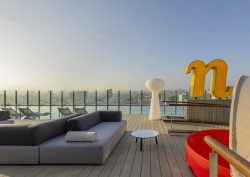 roof top view and terrace with pool and signage at nhow_Lima