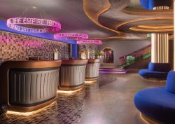 blue couches, neon lighting and reception desks in nhow Roma lobby