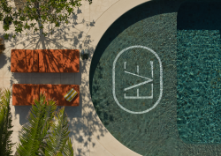 birds eye view of pool with The EVE logo and orange sunlounger