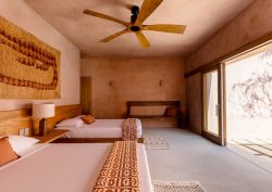 earthy tones, wooden fan, woven wallhanging in Casa Coco