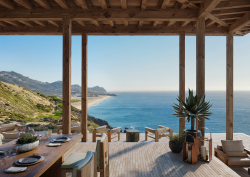 outdoor wooden deck on the edge of a cliff with sea view in Los Cabos
