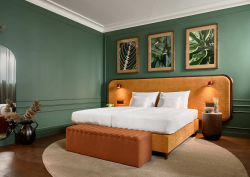 green walls and terracotta headboard in guestroom at Verno House Budapest